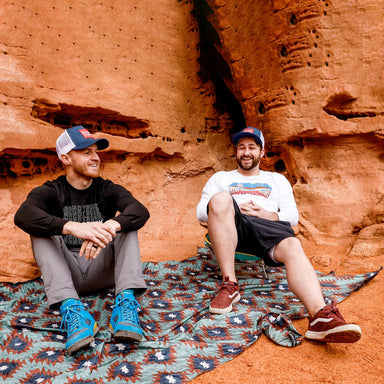 Two guys relaxing on a Adventure Sheet from Grand Trunk