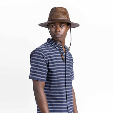 Man wearing a striped shirt and a straw hat on a white background